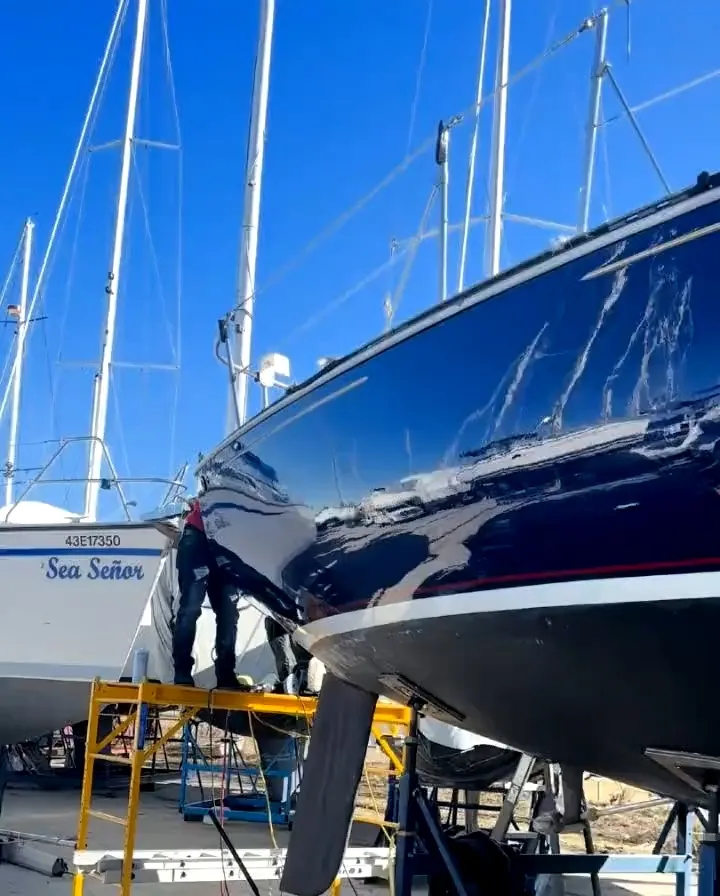 Navy sailboat hull polished on the hard